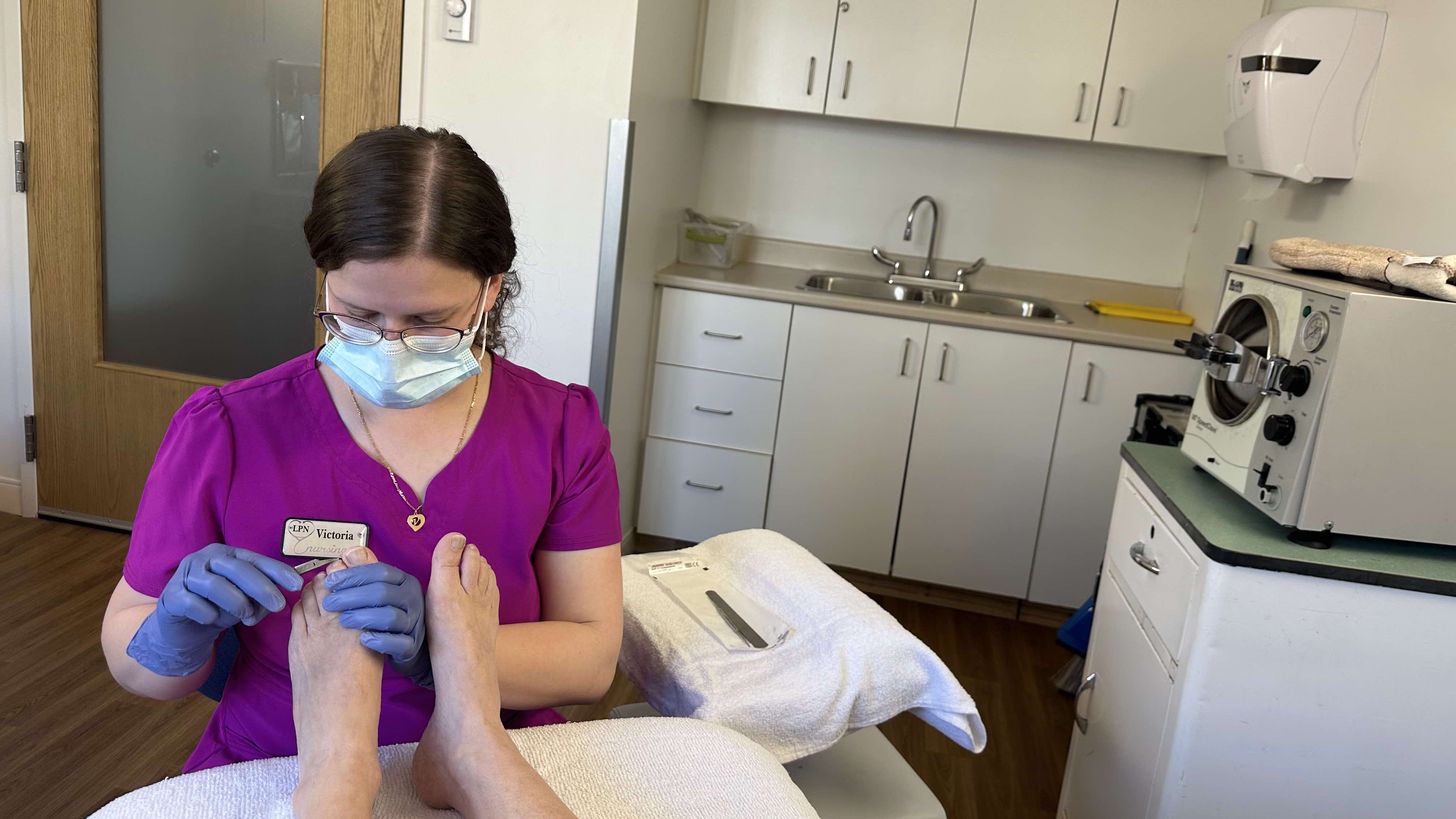 Victoria performing foot care.